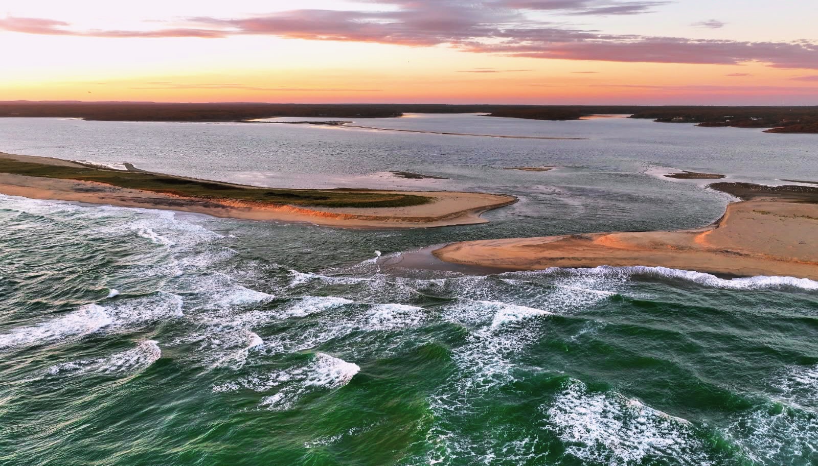 🌅 Sunset over the cut. Edgartown Great Pond is still open and tidal. Our team counted seagrass (eelgrass and widgeon grass) along 3️⃣transects 📏. We are happy to report the seagrass looks healthy, the water is crystal clear, salty🧂, and quite chilly 🥶. We took a cold plunge for science. This beautiful photo is courtesy of @sully7777777777 #sunset #drone #ocean #beach #marthasvineyard